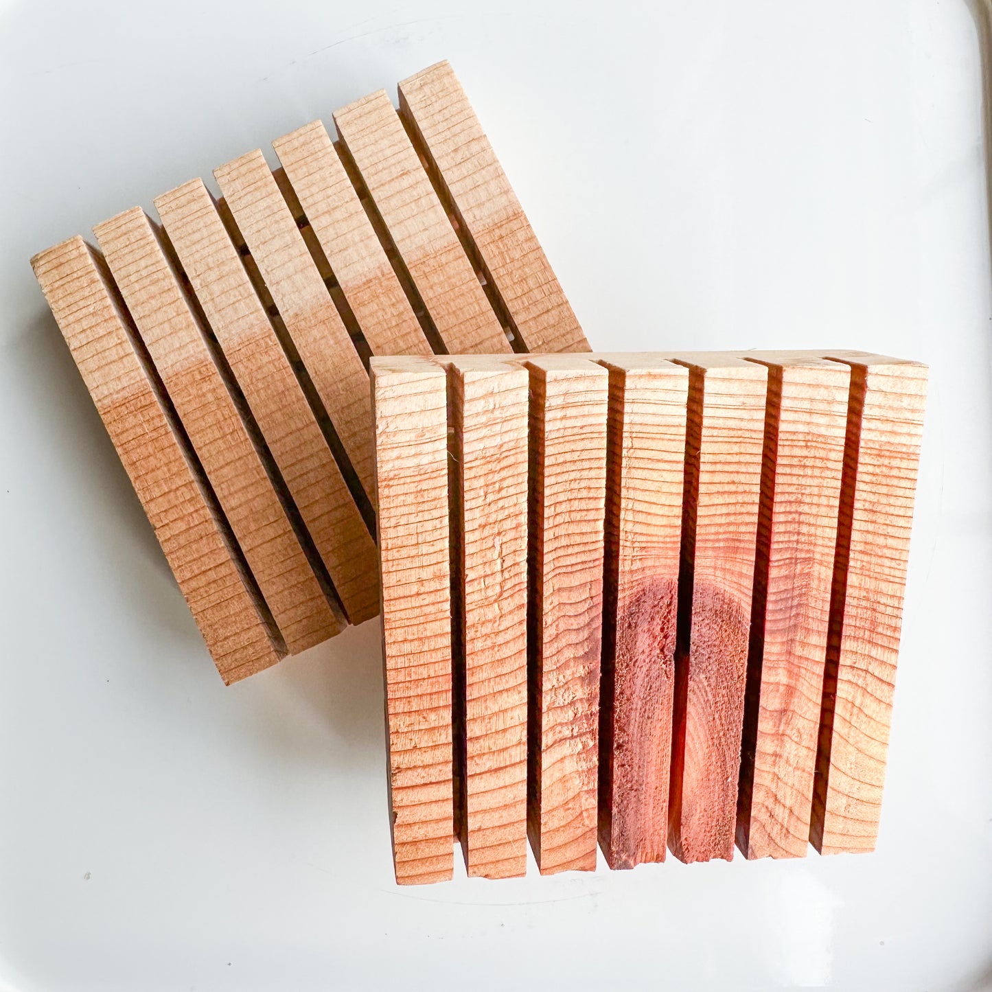 Two slotted flat squares of cedar. Varigated natural color