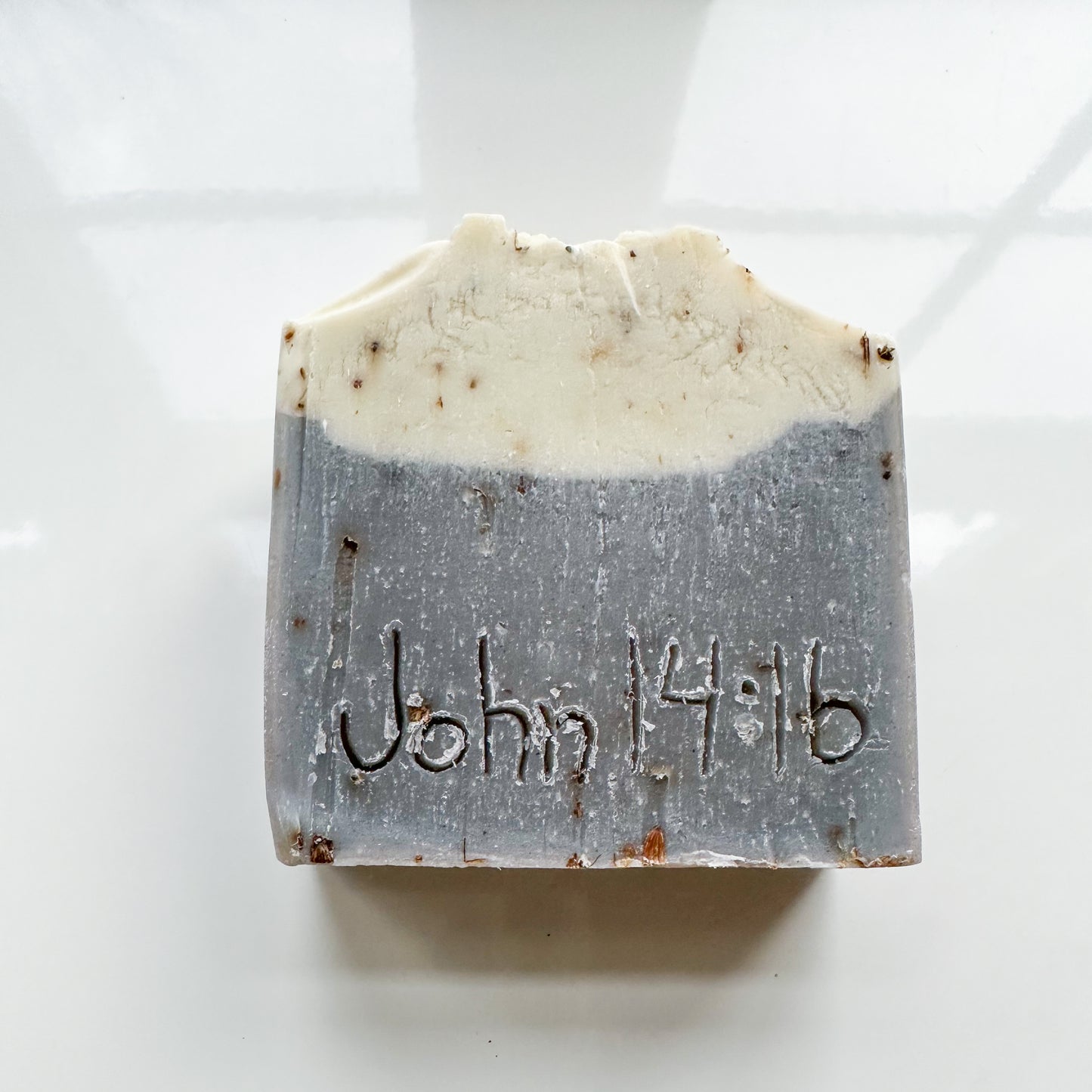 Purple bottom, white top bar without product sleeve. John 14:16 is etched in the bar.