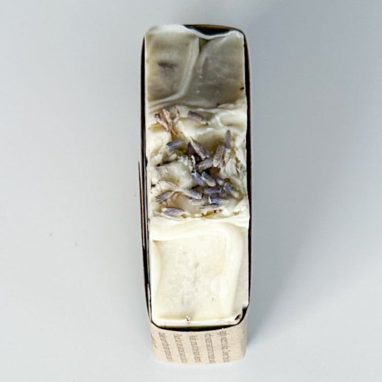 White bar top with two waves in the center. In the center of the two waves rests lavender buds embedded.