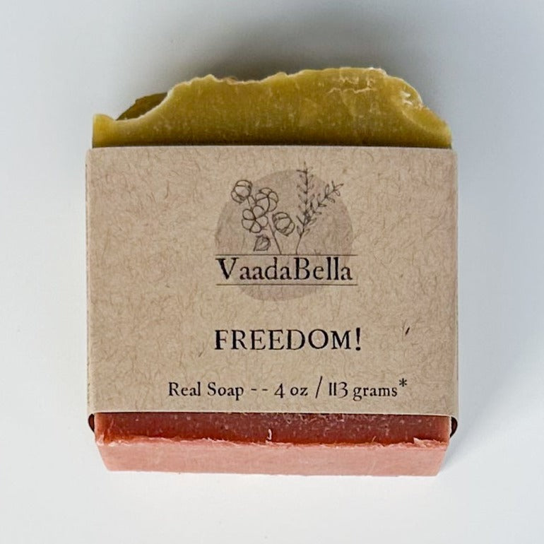 Red bottom, green top bar with kraft paper sleeve. Black ink prints the logo, "FREEDOM!" and "Real Soap -- 4 oz / 113 grams*