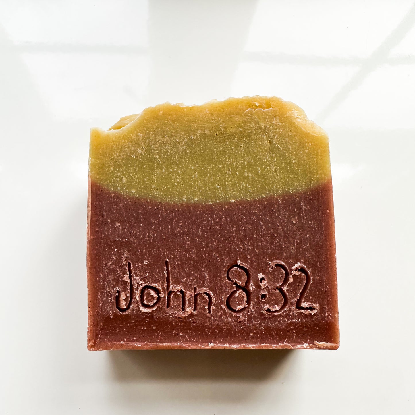 Freedom bar, green on top, brick red on the bottom, no product sleeve. "John 8:32" can be read etched into the bar.