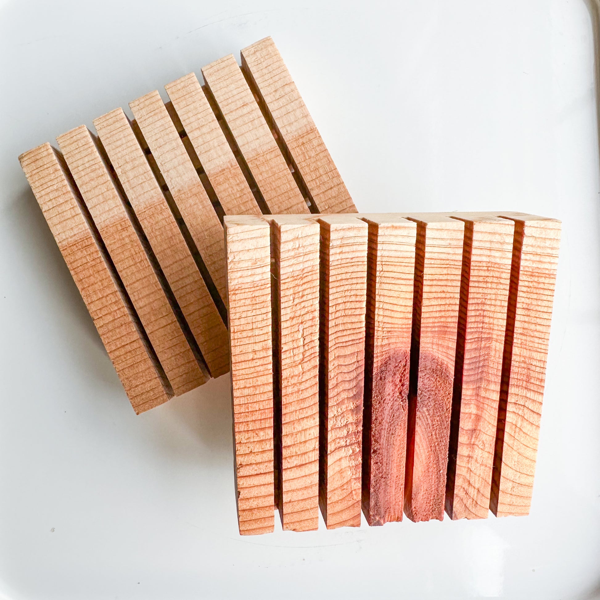 Two slotted flat squares of cedar.  Varigated natural color