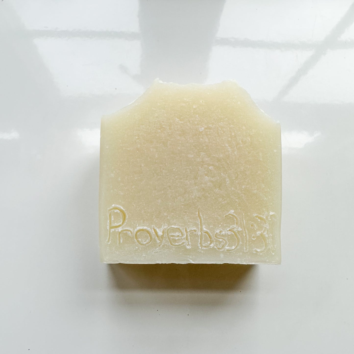 White bar with proverbs 31:30 etched into the bar