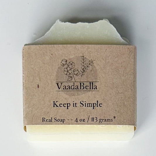 White bar, kraft paper product sleeve centered.  Black ink prints the logo, "Keep it simple" and "Real Soap -- 4 oz / 113 grams*"