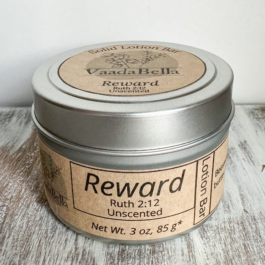 Front view of a circular silver metallic tin with lid.  brown kraft paper circle label centered. on the top, Logo, "Solid Lotion Bar" "reward" "Ruth 2:12" "Unscented" is all printed in black ink.  On the front, brown kraft paper sleeve wraps around the side of the tin with "Reward" "Ruth 2:12" "Unscented" "Net wt. 3 oz, 85 g*" printed on it
