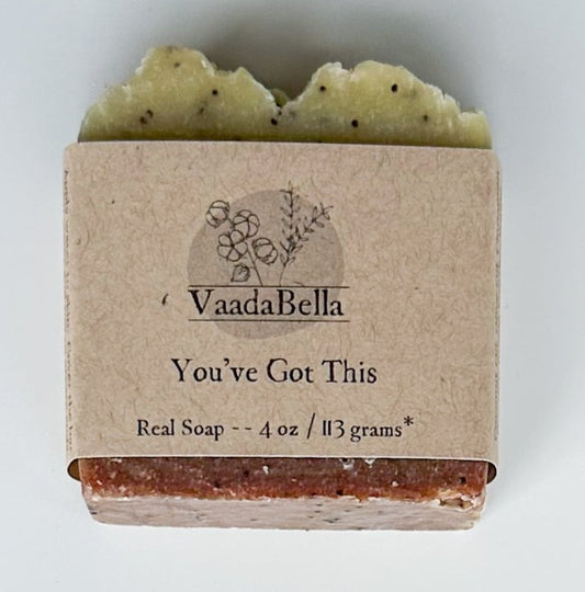 Brown bottom, light yellow top with black dots bar with kraft paper product sleeve centered on bar.  Black ink prints the brand logo, "You've Got This" and "Real Soap -- 4 oz / 113 grams*"