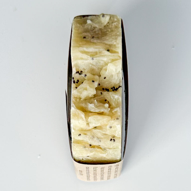Buttery Yellow bar top with black poppy seeds sprinkled in the wavy texture of the bar.